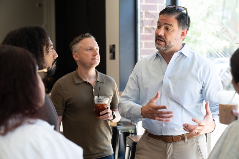 Daniel mid-conversation with residents at a local cafe
